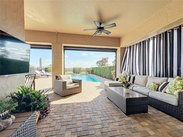 view of patio with a fenced in pool, outdoor lounge area, and ceiling fan