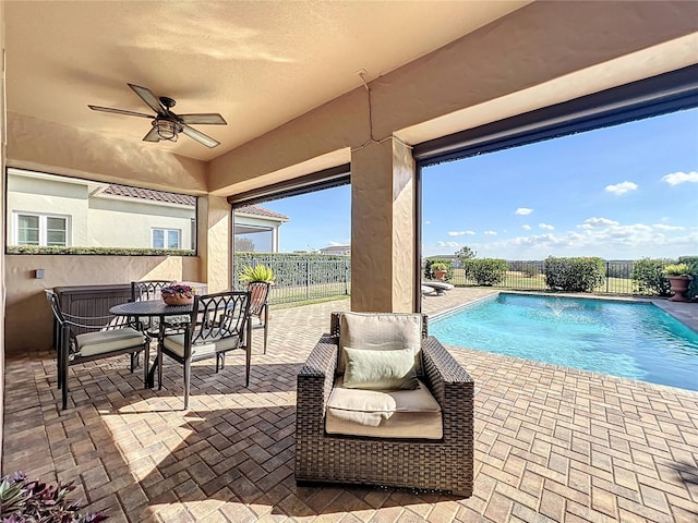 view of pool featuring a patio area, pool water feature, and ceiling fan