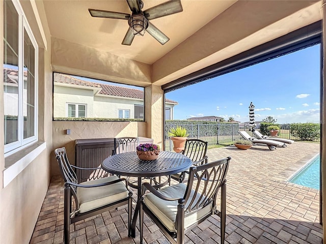 view of patio featuring ceiling fan and a fenced in pool