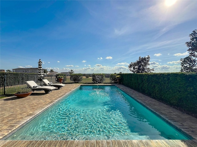 view of swimming pool with a patio and pool water feature