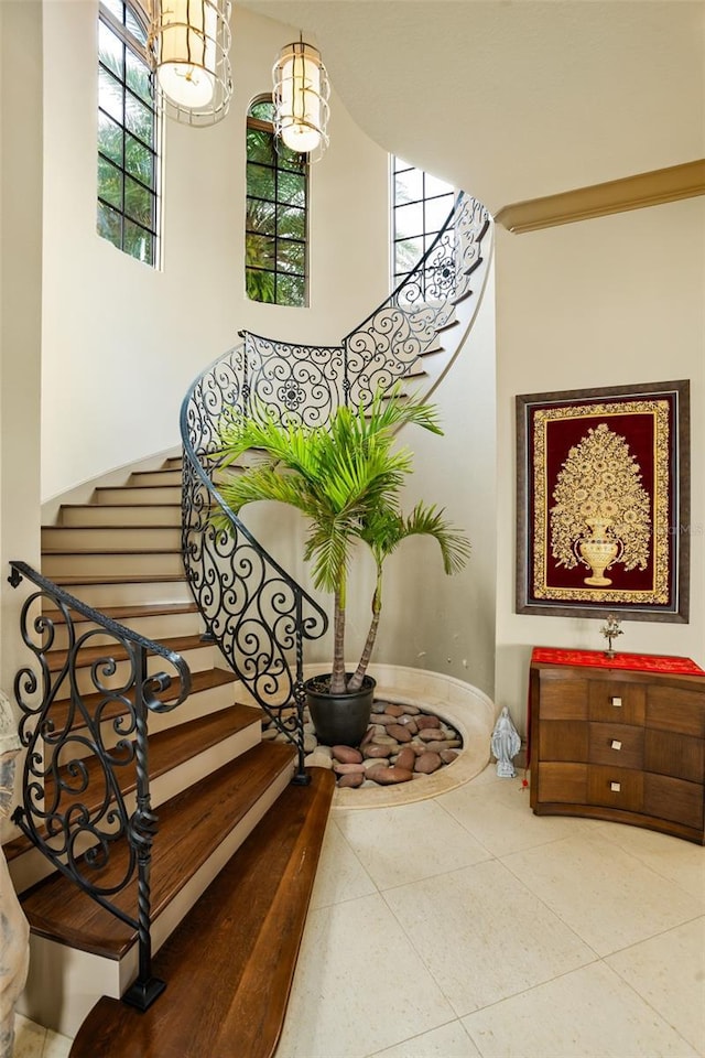 stairway with baseboards and tile patterned flooring