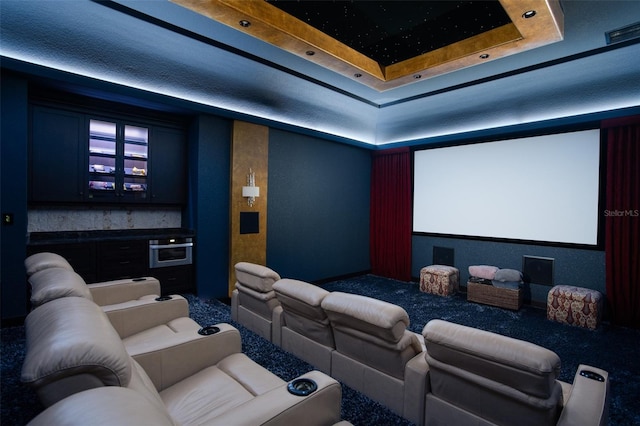 cinema room with a raised ceiling and visible vents