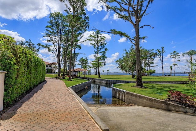 view of home's community featuring a yard and a water view