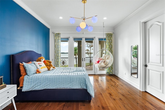 bedroom featuring hardwood / wood-style flooring, crown molding, baseboards, and access to outside