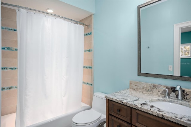 bathroom featuring tiled shower / bath combo, toilet, and vanity