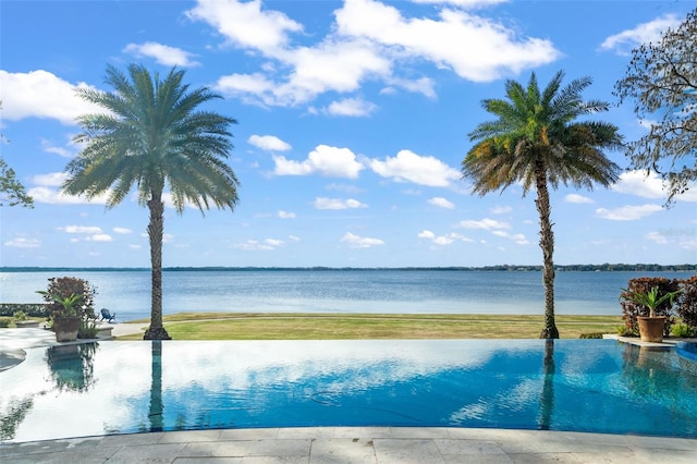 view of pool featuring a water view