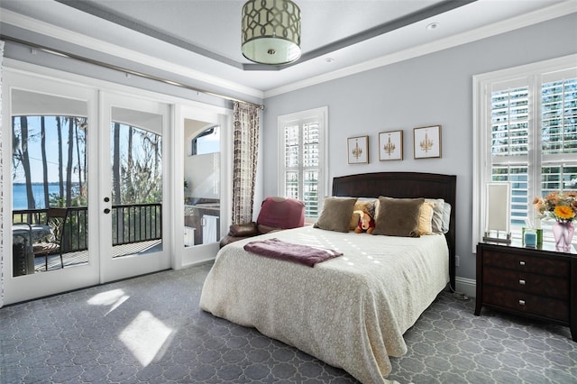 carpeted bedroom with multiple windows, french doors, crown molding, and access to outside