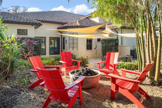 view of patio featuring a fire pit and central AC unit