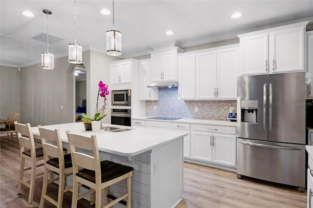 kitchen with pendant lighting, white cabinetry, a center island with sink, and appliances with stainless steel finishes