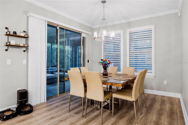 dining space with hardwood / wood-style flooring, a wealth of natural light, and ornamental molding