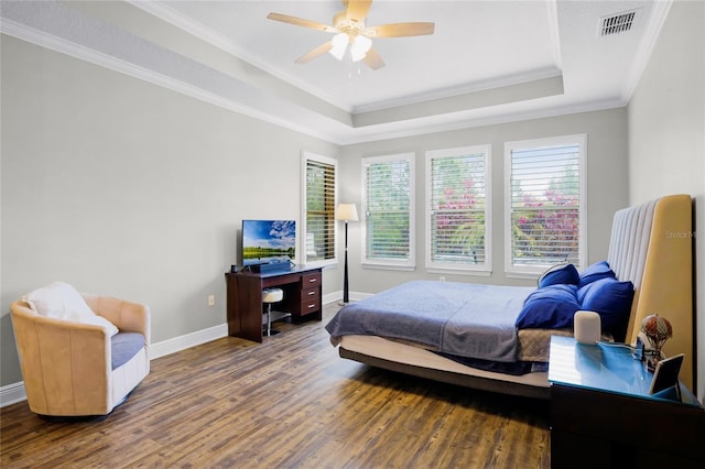 bedroom with dark hardwood / wood-style flooring, ornamental molding, a raised ceiling, and ceiling fan