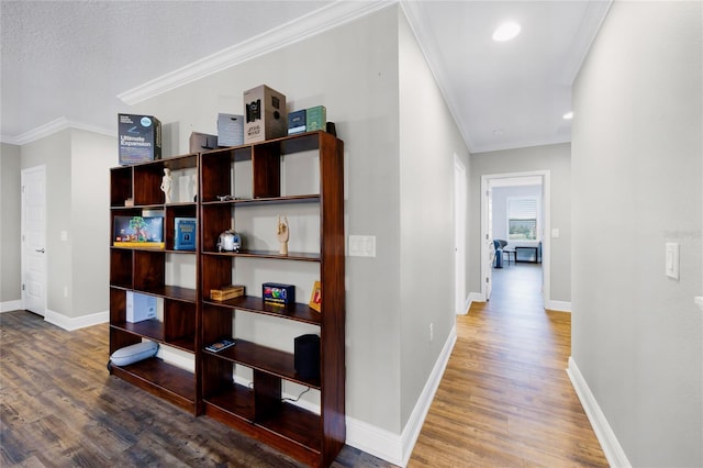 hall with crown molding and wood-type flooring