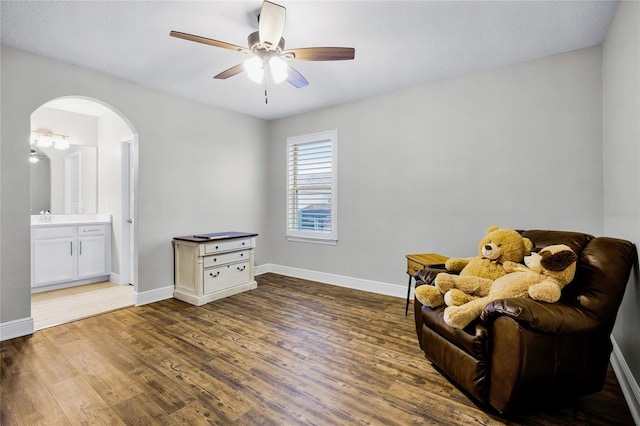 living area with hardwood / wood-style floors and ceiling fan