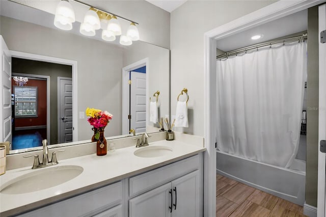 bathroom featuring vanity, hardwood / wood-style floors, and shower / bath combo with shower curtain