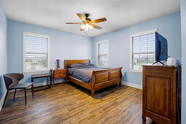 bedroom featuring dark hardwood / wood-style floors and ceiling fan