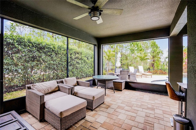 sunroom with ceiling fan