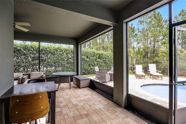 sunroom with ceiling fan