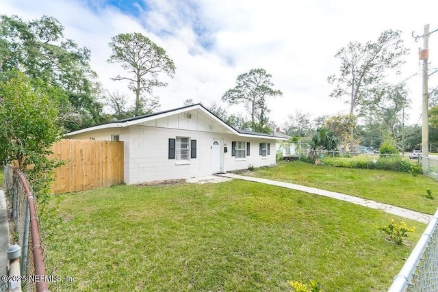 rear view of house featuring a yard