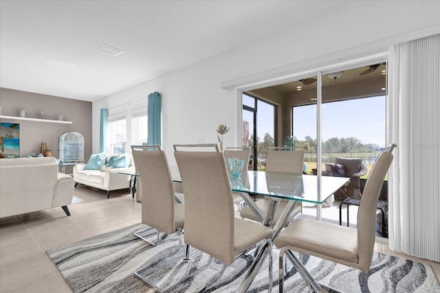 dining space featuring light tile patterned floors