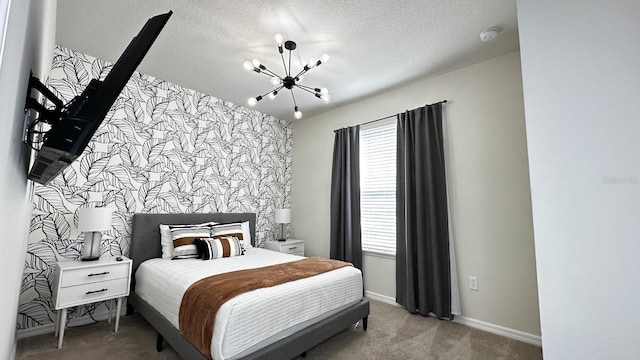 carpeted bedroom featuring a textured ceiling and a notable chandelier