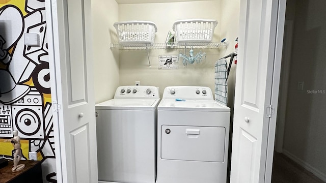 clothes washing area with washing machine and dryer