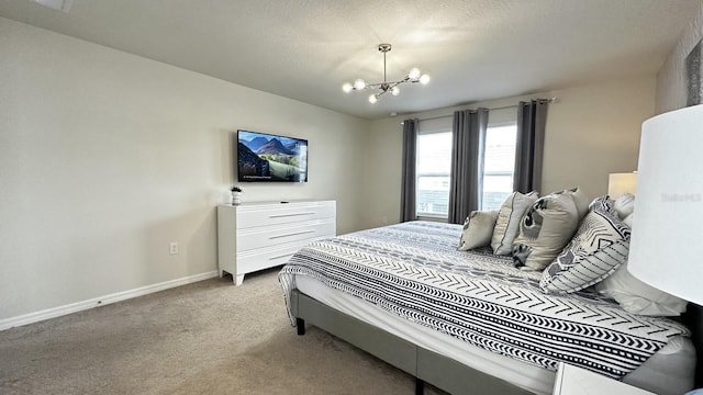 carpeted bedroom featuring an inviting chandelier