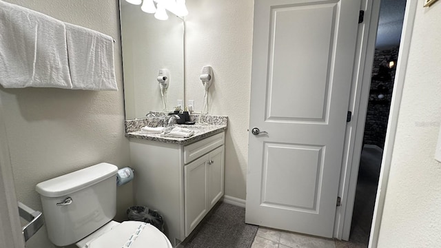 bathroom featuring vanity, toilet, and tile patterned flooring