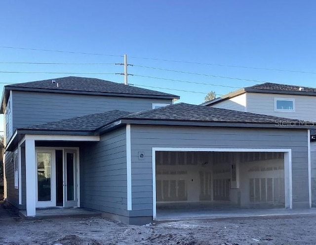 back of property featuring a garage