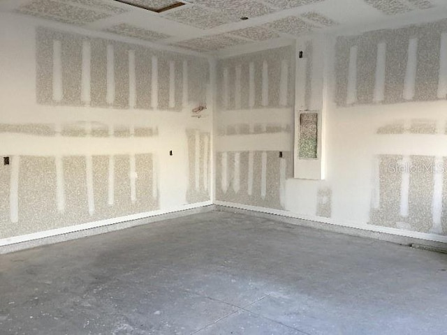 unfurnished room featuring concrete floors