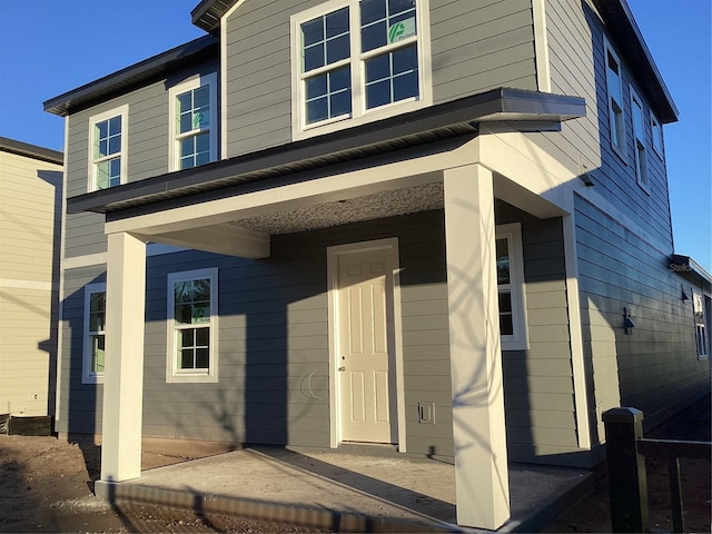 view of front of property with a patio and cooling unit