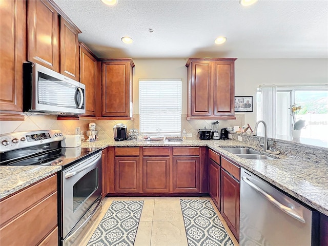 kitchen featuring sink, backsplash, plenty of natural light, and stainless steel appliances