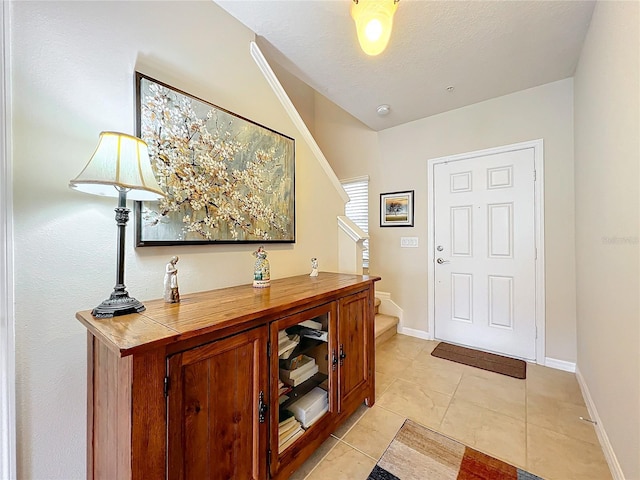 interior space with light tile patterned floors and a textured ceiling