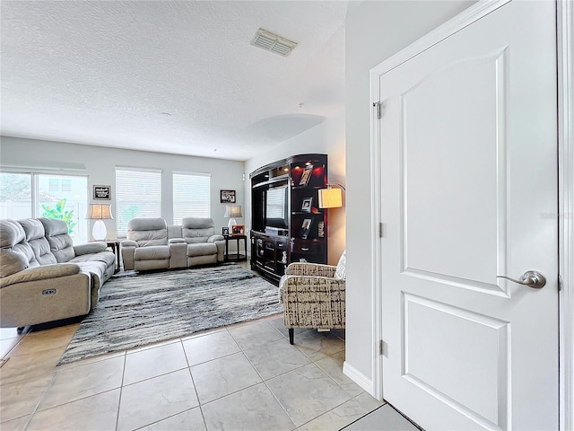 living room with light tile patterned floors and a textured ceiling