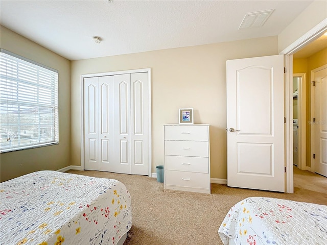 carpeted bedroom featuring a closet