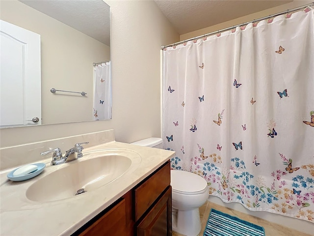 bathroom with vanity, tile patterned floors, a textured ceiling, and toilet