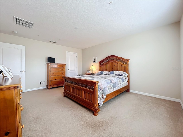 carpeted bedroom featuring a textured ceiling