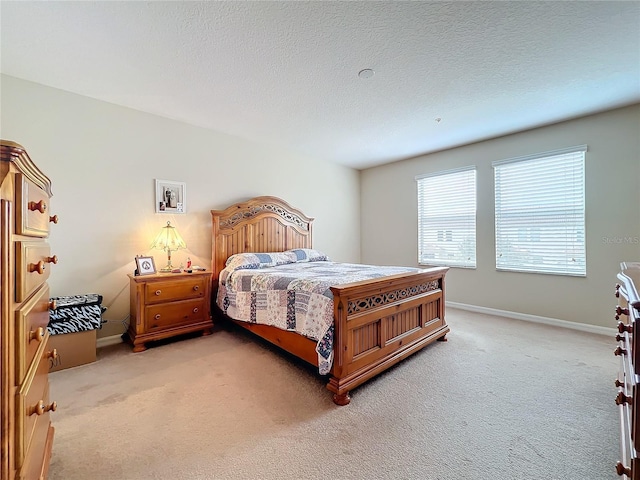 bedroom with carpet and a textured ceiling