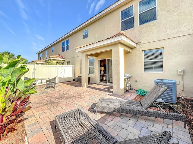 back of property featuring central AC and a patio area