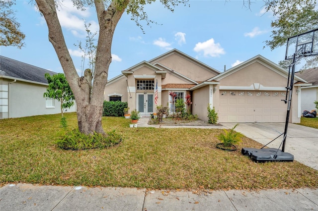 ranch-style house featuring an attached garage, a front yard, concrete driveway, and stucco siding