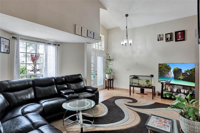 living room featuring light tile patterned floors, a textured ceiling, a chandelier, baseboards, and vaulted ceiling