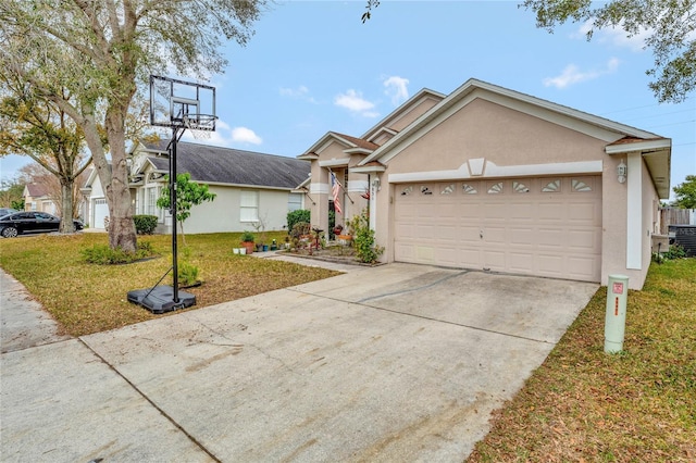 ranch-style home with a garage, a front yard, concrete driveway, and stucco siding