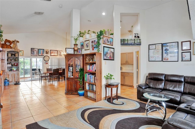 living room featuring high vaulted ceiling, light tile patterned flooring, and visible vents