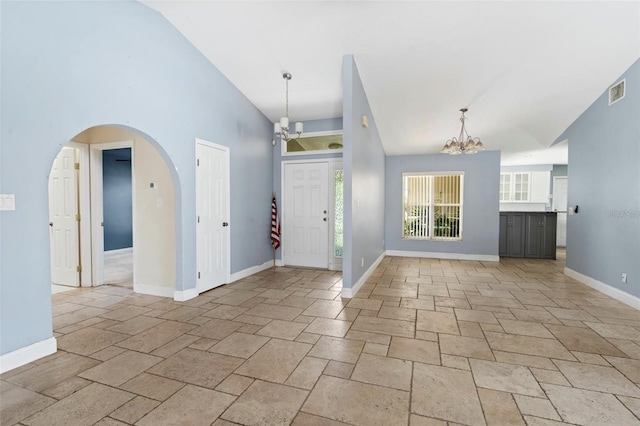 entrance foyer with high vaulted ceiling and a notable chandelier