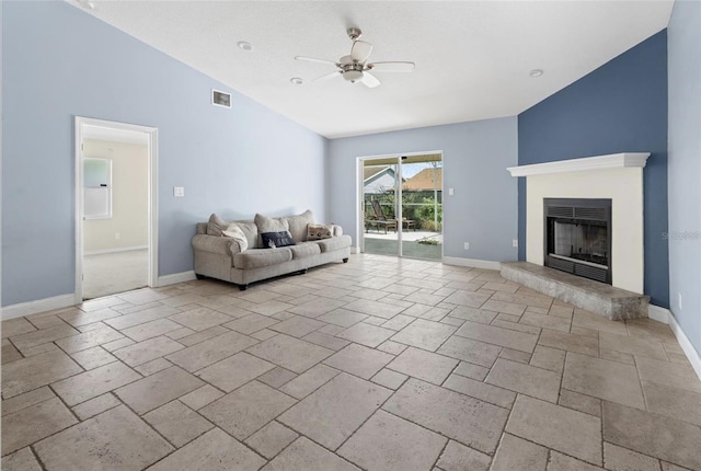 unfurnished living room with ceiling fan and vaulted ceiling