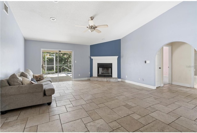 unfurnished living room featuring a textured ceiling and ceiling fan