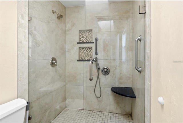 bathroom with an enclosed shower and toilet