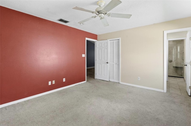 unfurnished bedroom featuring light carpet, a closet, and ceiling fan