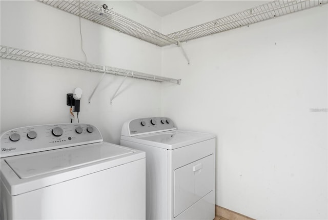 laundry room with washing machine and clothes dryer