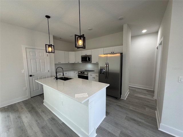 kitchen with white cabinetry, sink, decorative light fixtures, and appliances with stainless steel finishes