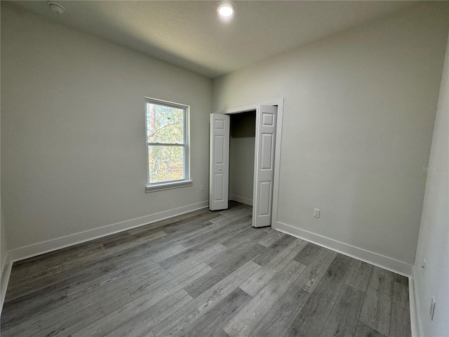 unfurnished bedroom with a closet and light hardwood / wood-style flooring